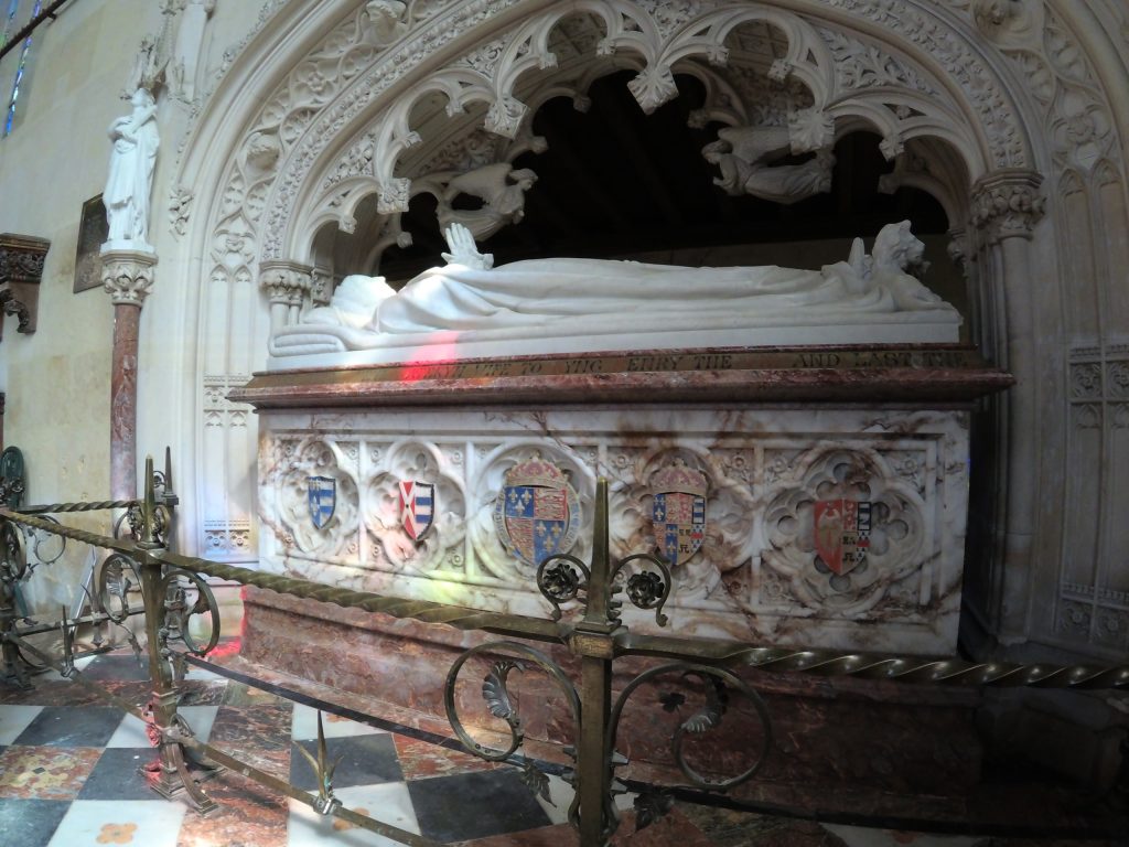 The ornate marble tomb of Katherine Parr with her white marble effigy above it.