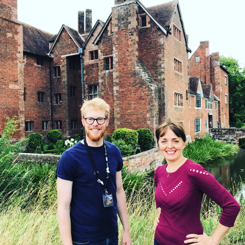 Two people outside Harvington Hall