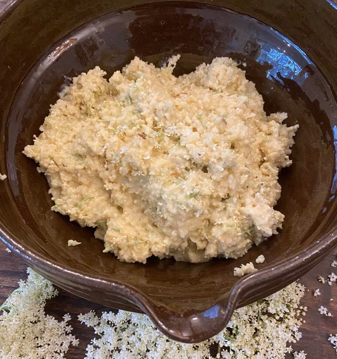 A bowl of dough for elderflower fritters.