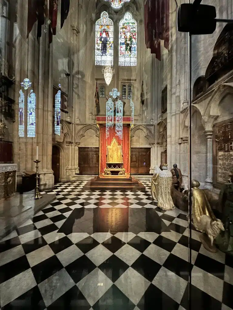 The Coronation Chair inside a glass cabinet in Westminster Abbey.