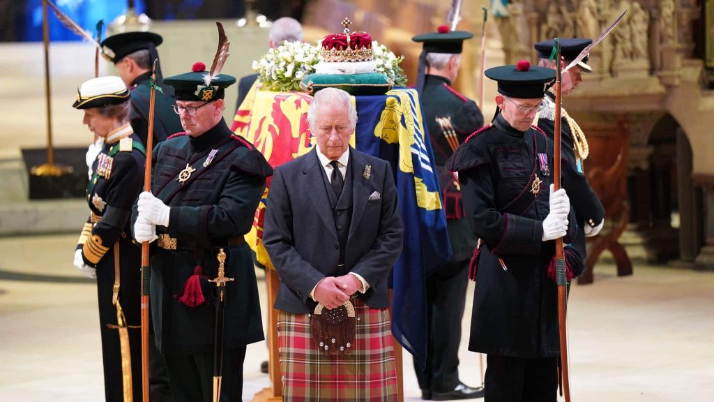 The Queen lying in state surrounded by a guard of honour